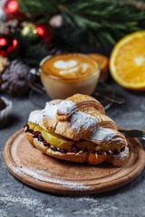 Obraz na płótnie Canvas New Year's breakfast with croissants. New Year's croissant with chocolate and baked orange