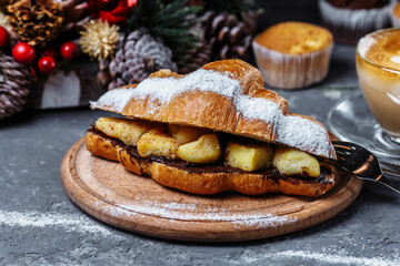 New Year's breakfast with croissants. New Year's croissant with chocolate and baked pineapple
