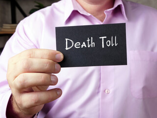 Financial concept meaning Death Toll  with sign on the page.
