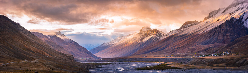 Serene Landscape of Spiti river valley & snow capped mountains during sunrise near Kaza town in Lahaul & Spiti district of Himachal Pradesh, India.