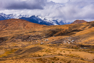 Bird eye aerial view of Hikkim village, famous for highest Post office of the world located in the cold desert valley of Spiti at elevation of 4400m in the Himalayas of Himachal Pradesh, India.