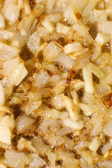 Fried yellow onions close up. Cooking onions on a pan.