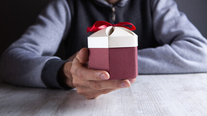 man holding a gift in his hand