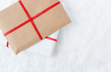 Gifts in a colorful packaging on a background of snow, icicles and snowflakes.