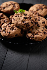 Homemade chocolate cookies on dark table