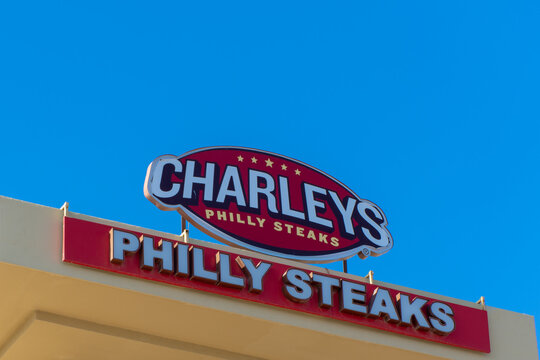 Charley's Philly Steaks sign on a blue sky background.