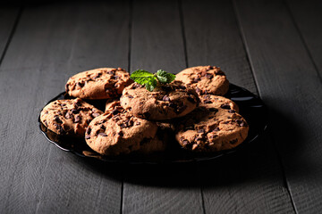 Homemade chocolate cookies on dark table