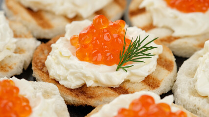 red caviar sandwiches with soft cheese close up