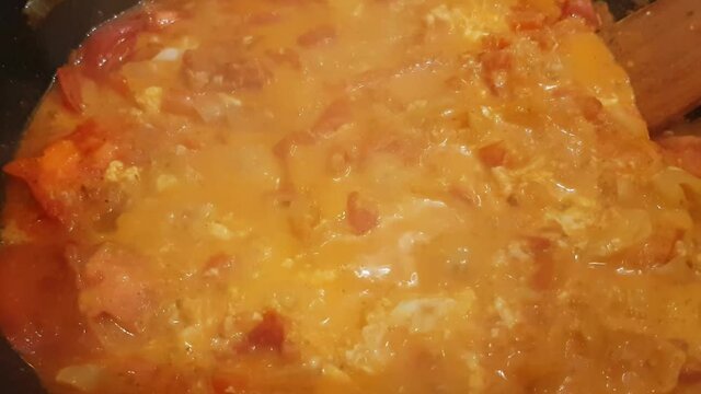 Cooking traditional Hungarian dish called lecs&oacute;
