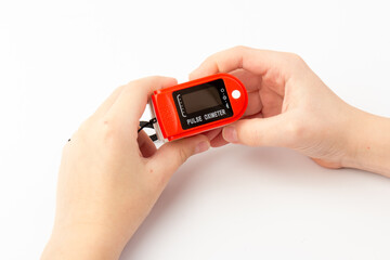 Pulse Oximeter, finger digital device to measure oxygen saturation in blood. Coronavirus symptoms concept.