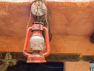 Antique miners oil lamp hanging from a wooden beam at a house in the clonial town of Villa de Leyva, in the central Andean mountains of Colombia.