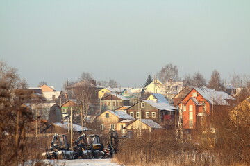 Fototapeta na wymiar Elegant multi-colored wooden village houses on a clear winter day.
