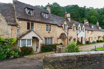 Fototapeta na wymiar Step back in time and visit Castle Combs, quaint village with well preserved masonry houses dated back to 13 century. Castle Combe, a picturesque medieval village in England. UK.