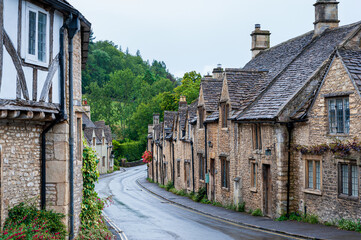 Fototapeta premium Step back in time and visit Castle Combs, quaint village with well preserved masonry houses dated back to 13 century. Castle Combe, a picturesque medieval village in England. UK.