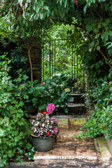 Step back into garden in Castle Combs, quaint village with well preserved masonry houses dated back to 13 century. Castle Combe, a picturesque medieval village in England. UK.