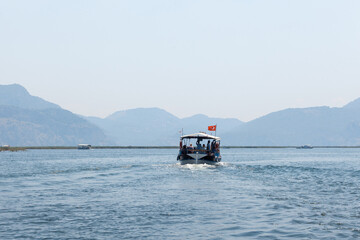 Boats with tourists floating on the river against the background of mountains