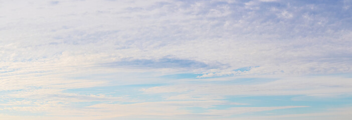 Panorama of the sky with unusual clouds at sunset