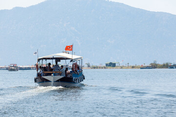 Boats with tourists floating on the river against the background of mountains