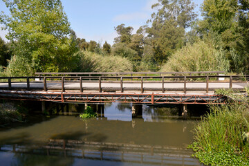 Fototapeta na wymiar Old rural bridge over canal