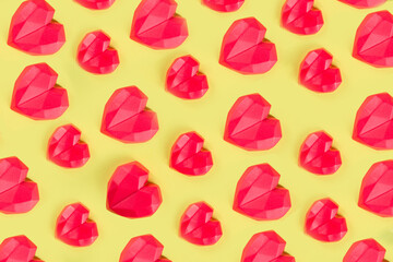 Red heart pattern, sweet red chocolate hearts on bright yellow background flatlay, above