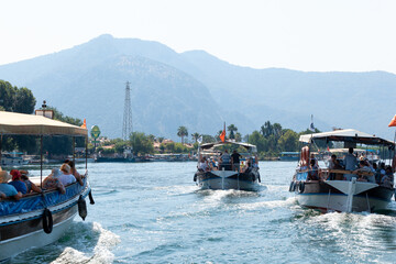 Boats with tourists floating on the river against the background of mountains
