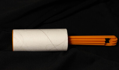 Roller for cleaning clothes with a sticky surface in the trash.