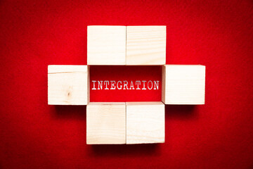 Wooden cubes with the word Integration. Concept of integration, uniting, making friends and...
