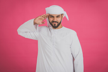 Handsome man with traditional white kandura from uae. Studio portraits on colored backgrounds with Dubai outfit, about fashion and lifestyle
