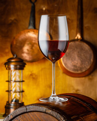 glass of red wine on wooden cask surface