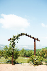 Arch with flowers for wedding ceremonies in the style of boho. 