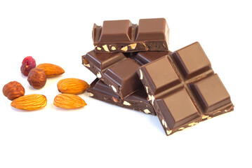 Broken pieces of milk chocolate with almonds and raisins on an isolated white background.