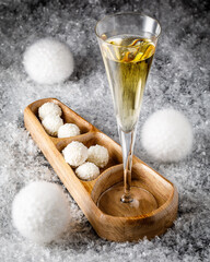 christmas still life with white chocolate truffles, cookies and sparkling wine