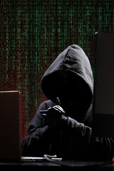 International hacker in black pullover and black mask trying to hack government on a black and red...