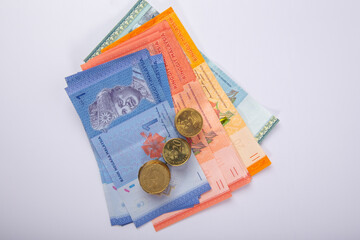 Stack Malaysia Bank note with coin on White Background.