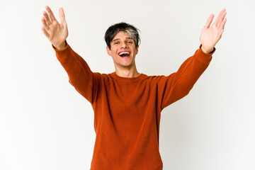 Young skinny hispanic man feels confident giving a hug to the camera.