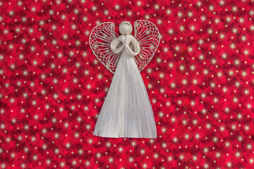 Straw Christmas decoration.Eco friendly rural ornament.Handmade Xmas wooden angel.Traditional craft product.Christmas background.Winter holiday seasonal decor copy space.Creative layout flat lay.