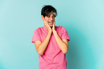 Young caucasian skinny man expressing emotions isolated on blue background