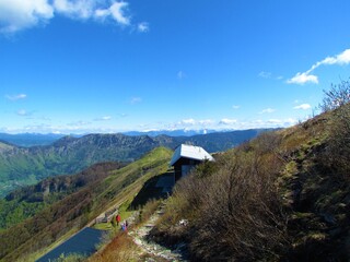 View of mountain hut at Porezen in Slovenia and mountains and hills behind