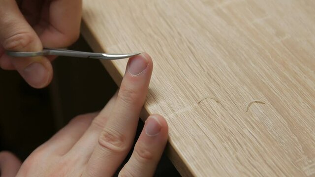 A man cuts nails hand caucasian white closeup