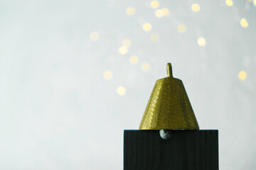 Golden bell on a white background. Silhouette. Symbol. Copy space. 
