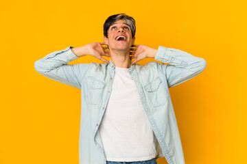 Young skinny hispanic man feeling confident, with hands behind the head.