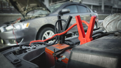 Car accumulator jump start cables close up.