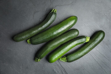 Green ripe zucchinis on black slate table, flat lay