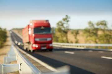 Fototapeta na wymiar Blurred view of asphalt highway with truck. Road trip