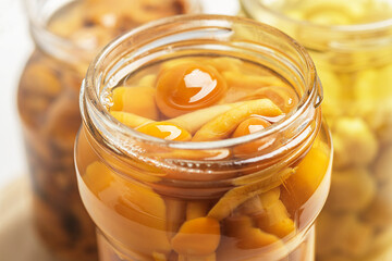 Canned mushrooms in banks close-up. Fermented products.