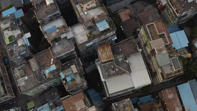 Fly over old rusty roofs of Dongshankou district buildings of Guangzhou city. Urban village in China. Asia