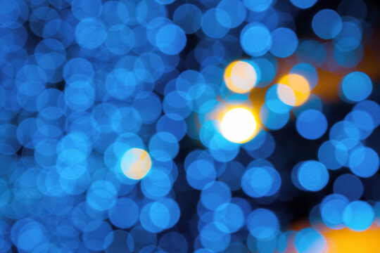 blue blurry Christmas lights on the streets. holiday night background with bokeh effect.