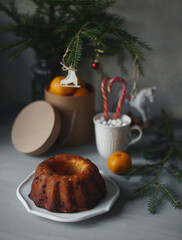 Spruce branch, pastries, toys are on the table.