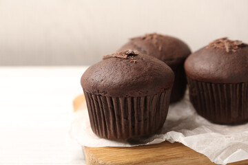 Delicious cupcakes with chocolate crumbles on white table, closeup
