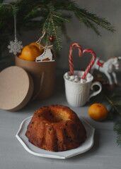 Spruce branch, pastries, toys are on the table.